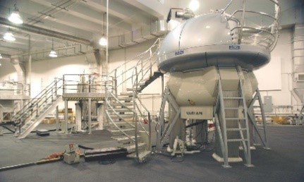 A large white machine with stairs leading to its upper platform.
